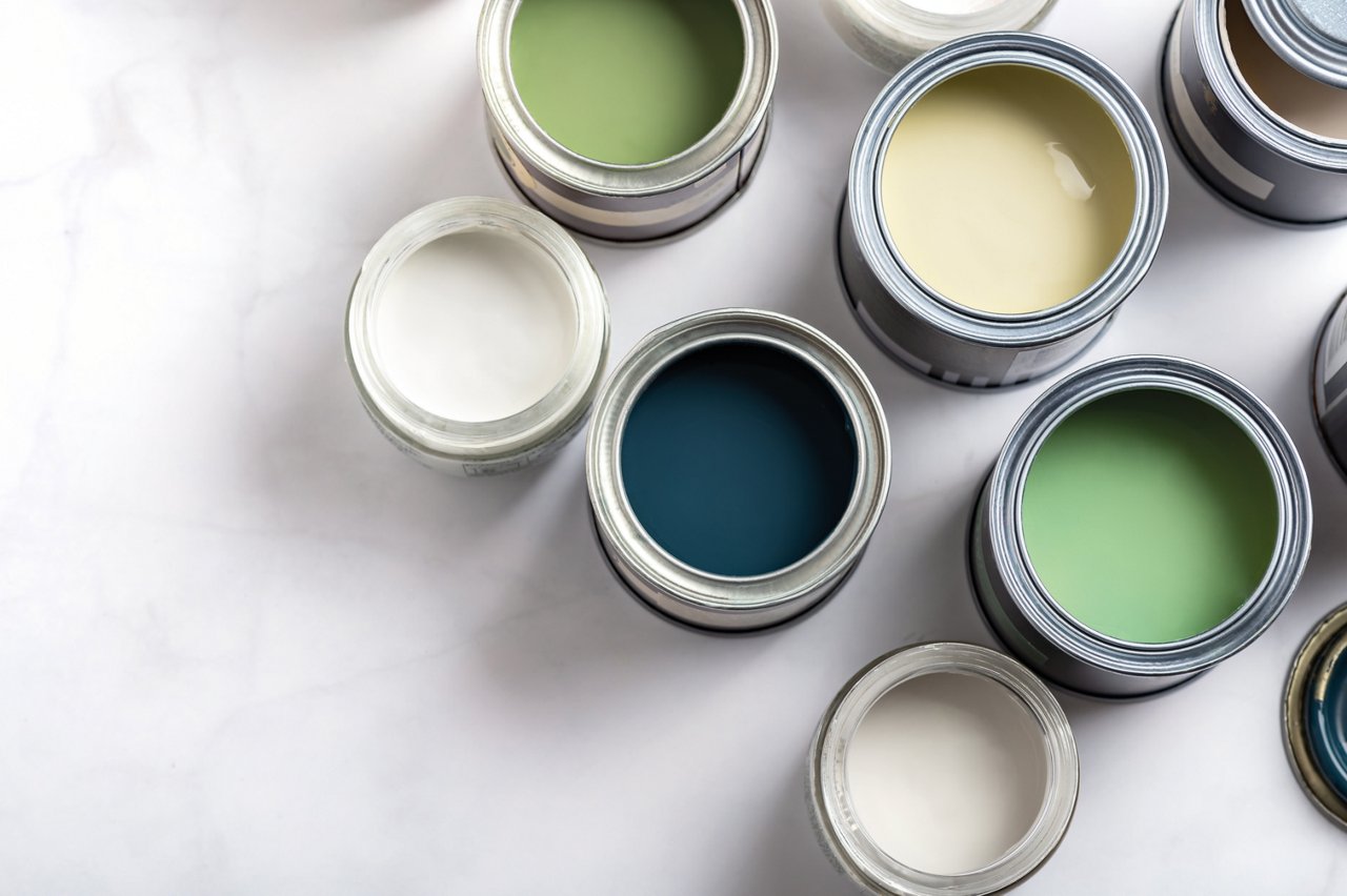 Paint cans during house renovation, process of choosing paint for the walls, different green and beige colors, color charts on background;; purchase_order: CON; job: SUS Toolkit brochure; client: ; other: 