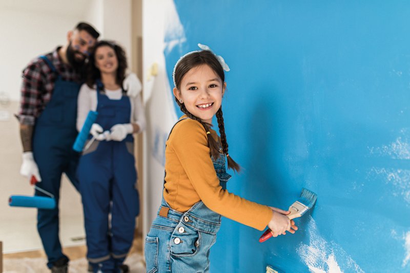 Happy family renovating their home. They are painting a wall together.; Shutterstock ID 1646906872; purchase_order: CON; job: ; client: ; other: 