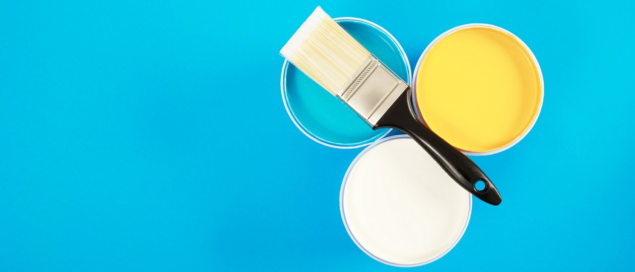 Brush handle on opened cans on blue pastel background. Yellow, white, watercolor acrylic paint. Top View. Banner of renovation concept.; Shutterstock ID 2008080584; purchase_order: CON; job: ; client: ; other: 