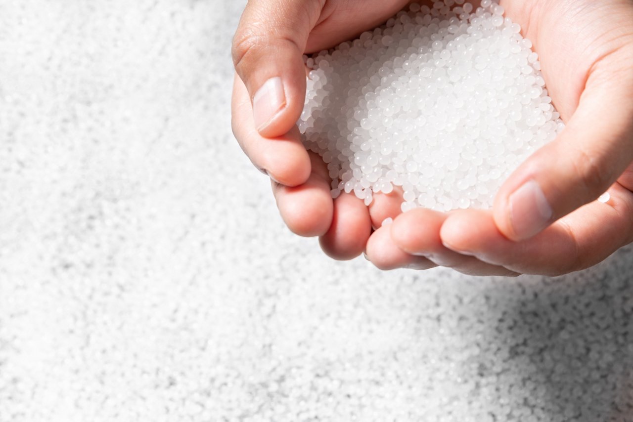 Engineer hold white plastic on hand polymer petrochemical product as polymer raw material for plastic in polymer chemical industry design and test in polymer science laboratory; Shutterstock ID 2227177255; purchase_order: POL_Website_Masterbatch & Compounds ; job: ; client: ; other: 