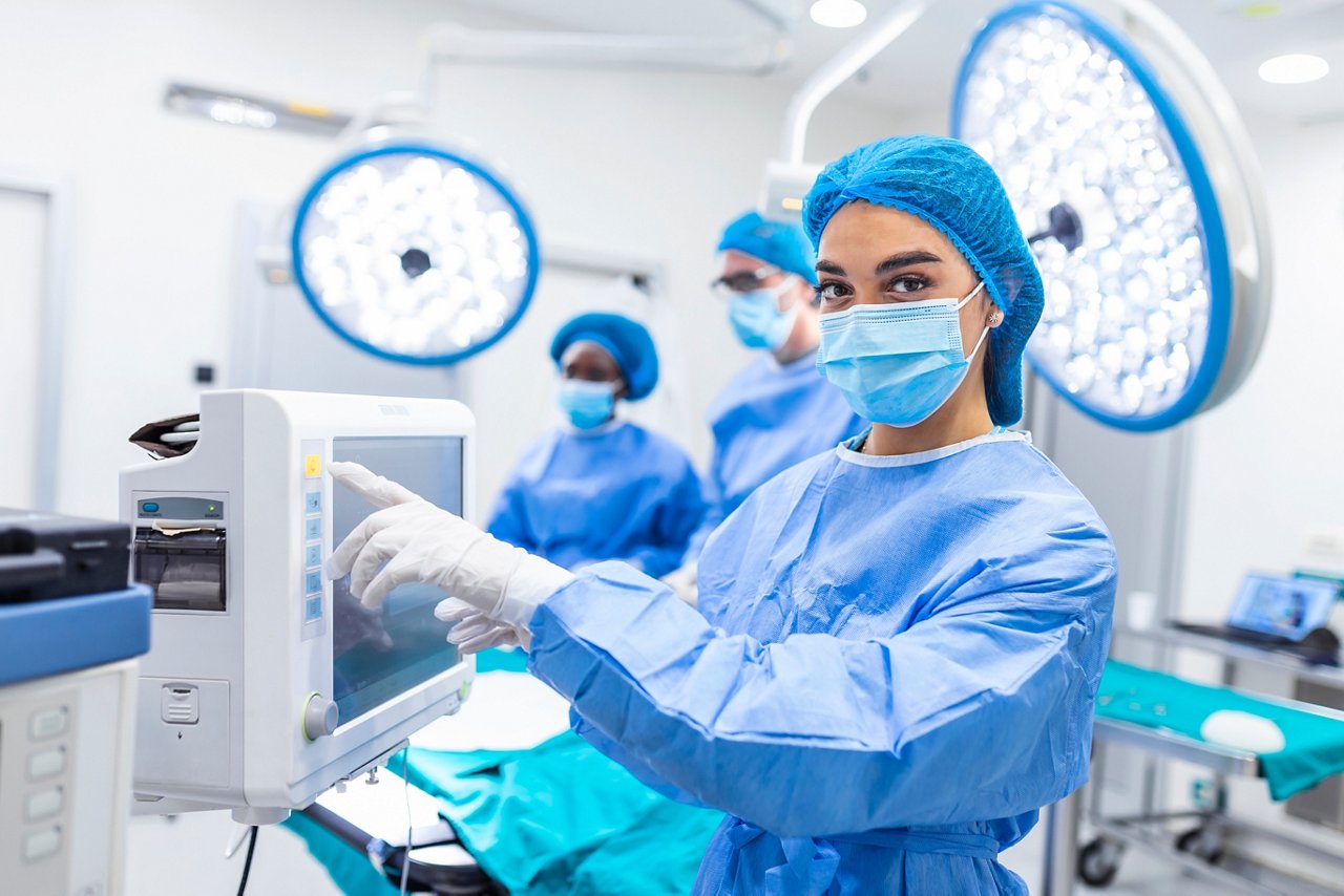 Diverse Team of Professional Surgeons Performing Invasive Surgery on a Patient in the Hospital Operating Room. Nurse Hands Out Instruments to surgeon, Anesthesiologist Monitors Vitals.; Shutterstock ID 1963299028; purchase_order: POL ABR Fibers & Nonwovens; job: ; client: POL ABR Fibers & Nonwovens; other: 