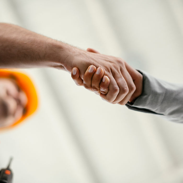 Close up of factory worker giving handshake to a engineer. Business handshake.; Shutterstock ID 1607487217; purchase_order: CON; job: ; client: ; other: 