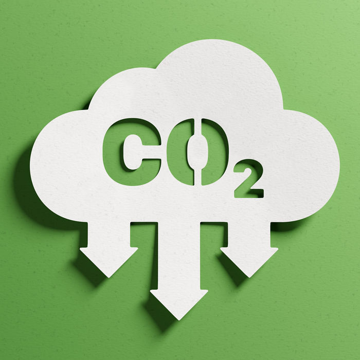 Reduce CO2 emissions to limit climate change and global warming. Low greenhouse gas levels, decarbonize, net zero carbon dioxide footprint. Abstract minimalist design, cutout paper, green background.; Shutterstock ID 2156662655; purchase_order: CON; job: CO2 reduction; client: CON; other: CON