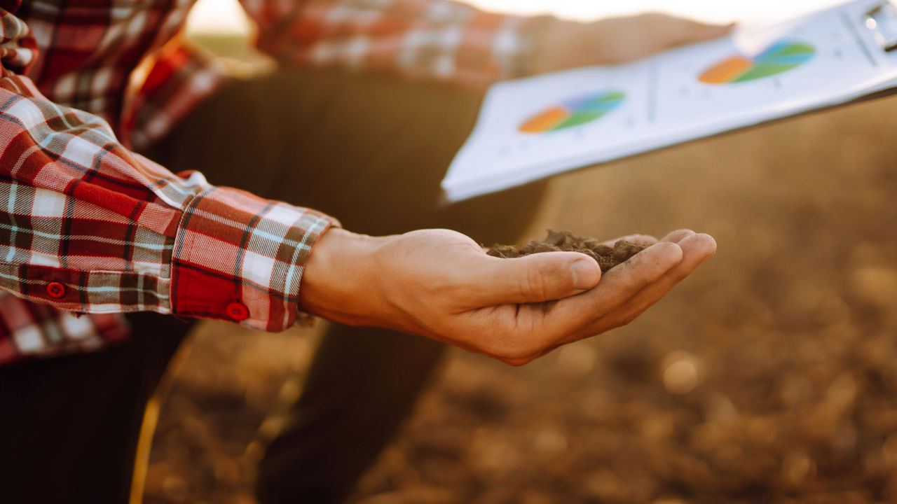 Farmer's hand with clipboard 