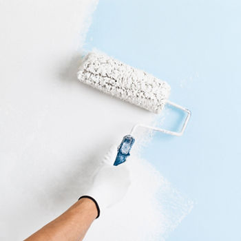 Close up of painter hand in white glove painting a wall with paint roller; copy space; Shutterstock ID 374666983; purchase_order: CON; job: P&C - Decorative paints, main applications; client: ; other: 