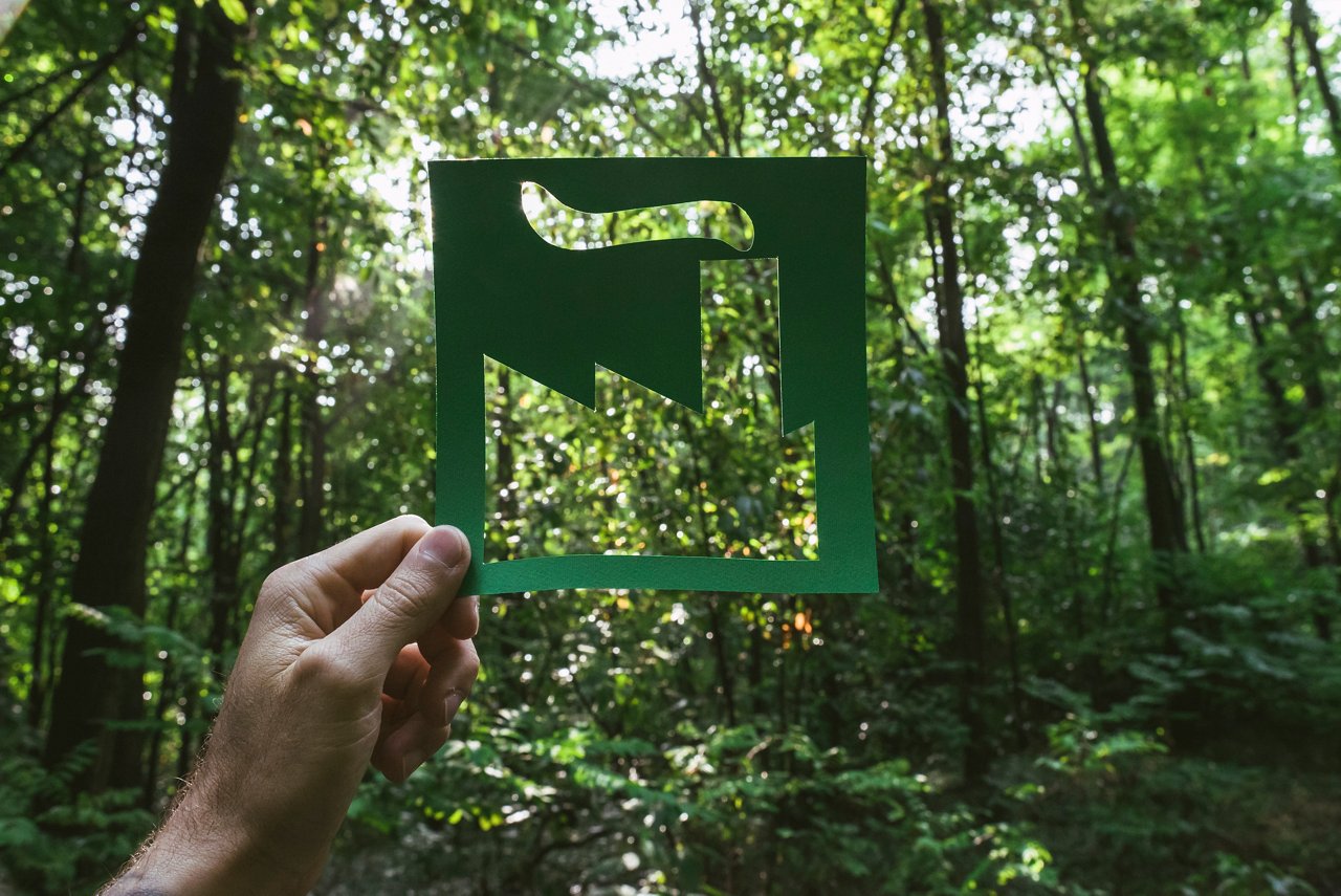 Hand holding green eco-friendly symbol