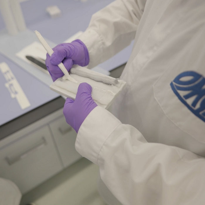 Lab technicians checking the consistency of a sealant formulation