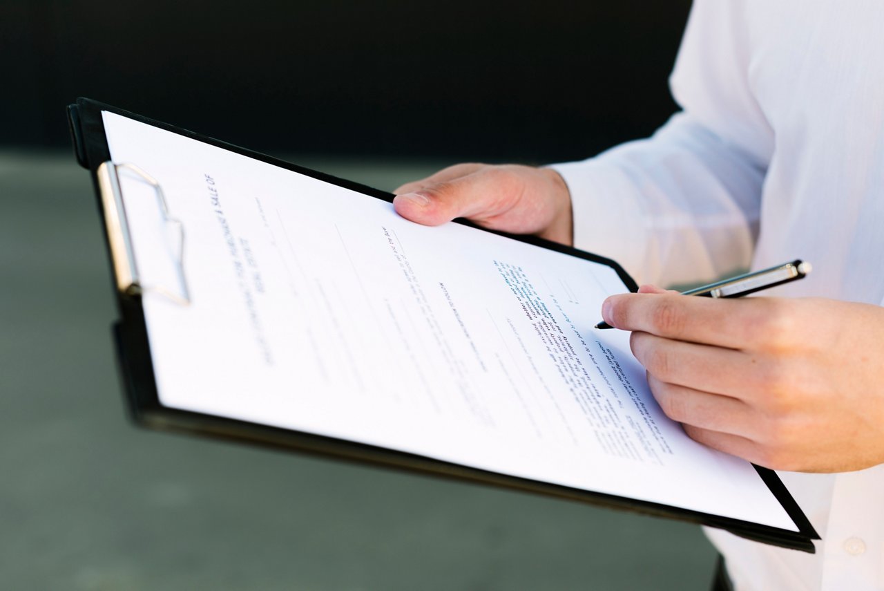 Man signing sales terms and conditions