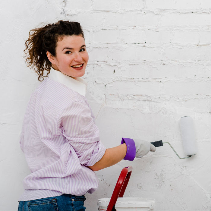 Woman painting wall