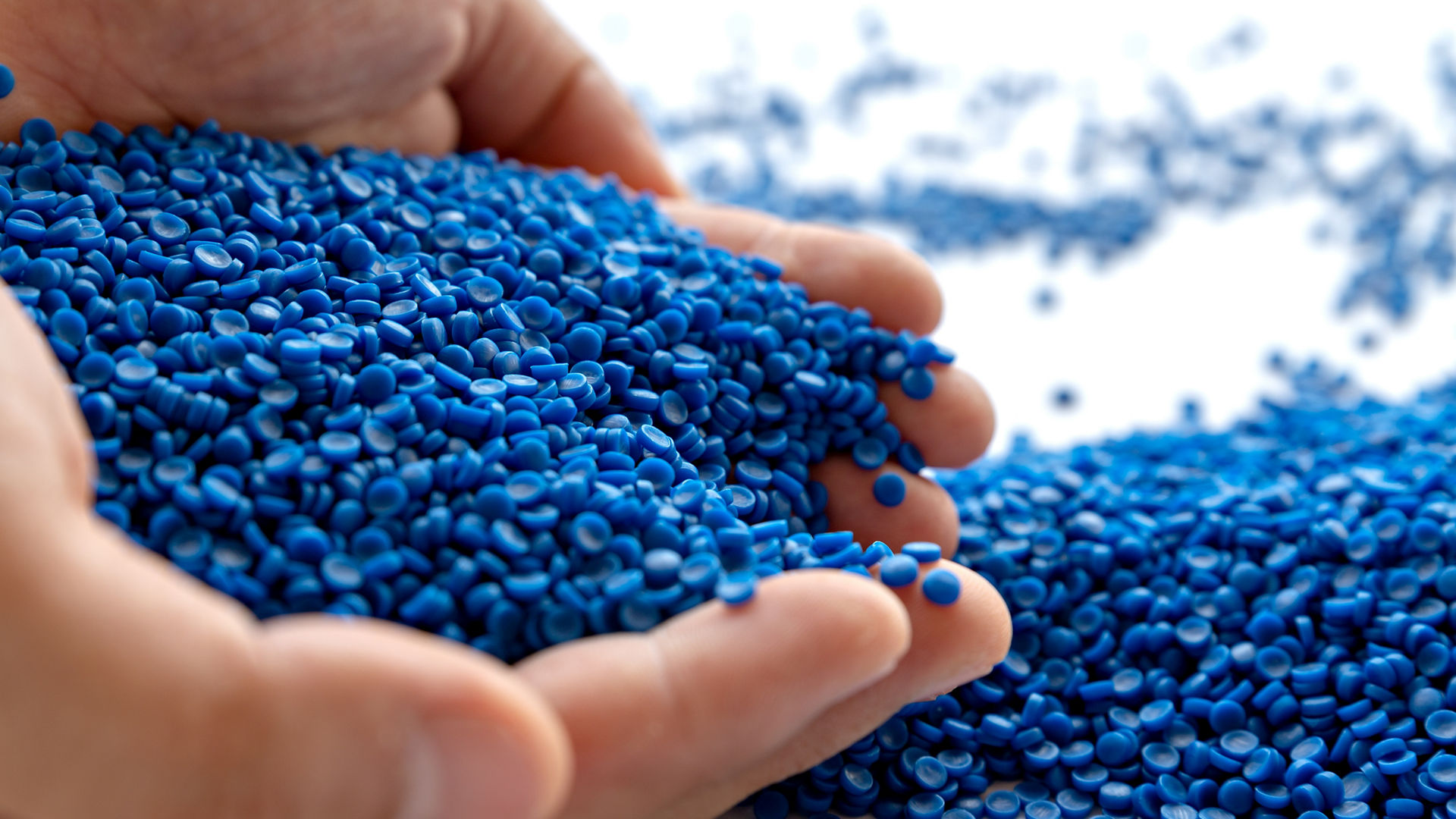 Blue plastic grain, plastic polymer granules,hand hold Polymer pellets, Raw materials for making water pipes, Plastics from petrochemicals and compound extrusion, resin from plant polyethylene.; Shutterstock ID 1805518771; purchase_order: -; job: -; client: -; other: -1805518771