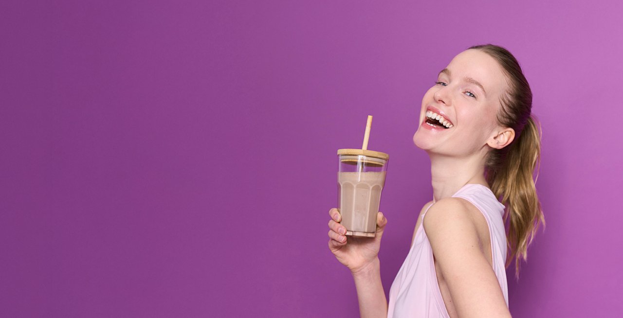 girl drinking a drink from a glass with a straw