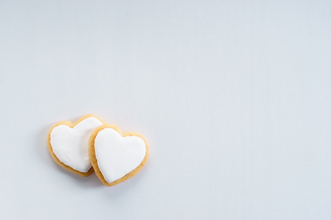 Heart cookies with sweet white icing on white background, top view. love concept.; Shutterstock ID 1162677565; purchase_order: CES; job: ; client: ; other: 