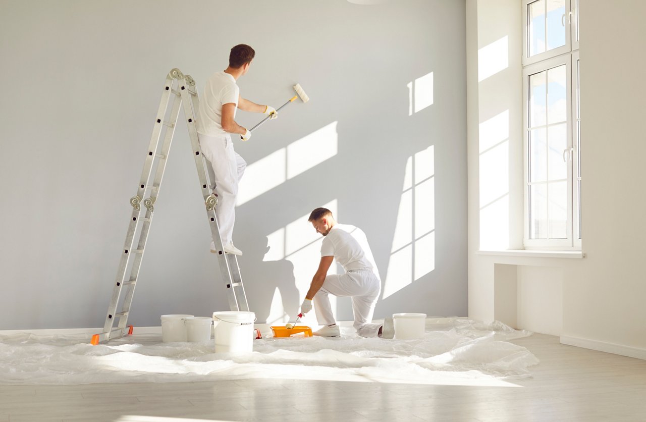 Team of professional painters in white clothes painting a grey wall in empty room with paint roller. Building contractors doing repair renovation in client house. Repair and renovating concept.; Shutterstock ID 2478830785; purchase_order: CON; job: ; client: ; other:
2478830785