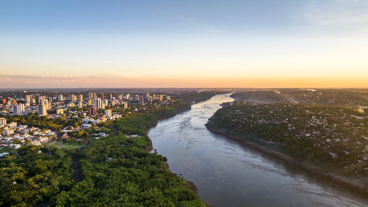 Border between Brazil and Paraguay and connects Foz do Iguaçu to Ciudad del Este. Ponte da Amizade in Foz do Iguaçu. Aerial view of the Friendship Bridge with Paraná river.
South America.; Shutterstock ID 2452763239; purchase_order: Locations Country landing pages; job: Locations Country landing pages; client: CG; other: 