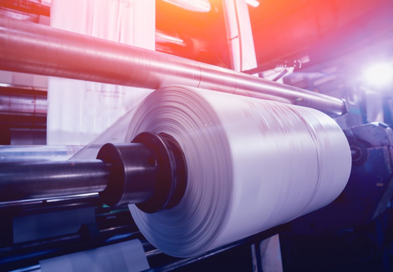 Modern automated production line in factory. Plastic bag manufacturing process. Background; Shutterstock ID 1208573524; purchase_order: POL_Website_Packaging ; job: ; client: ; other: 