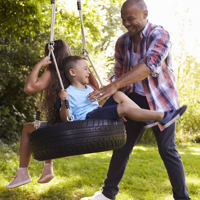 Father Pushing Children On Tire Swing In Garden; Shutterstock ID 496639498