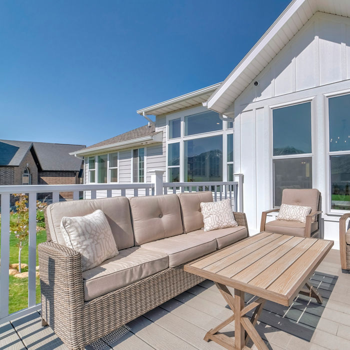 Patio of a house on a wooden deck with railings and woven furnitures; Shutterstock ID 2077975543; purchase_order: -; job: -; client: -; other: -