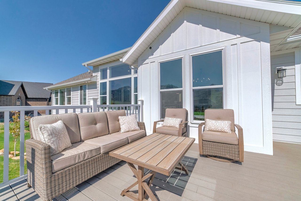 Patio of a house on a wooden deck with railings and woven furnitures; Shutterstock ID 2077975543; purchase_order: -; job: -; client: -; other: -