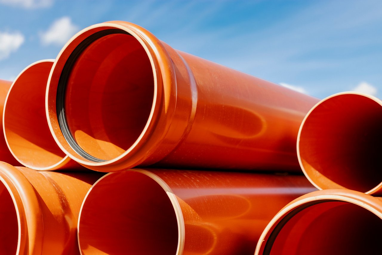 Orange sewer pipes at the construction site. Preparation for the installation of an underground sewer system. Wastewater disposal; Shutterstock ID 2145677637; purchase_order: POL_Website_Building materials; job: ; client: ; other: 