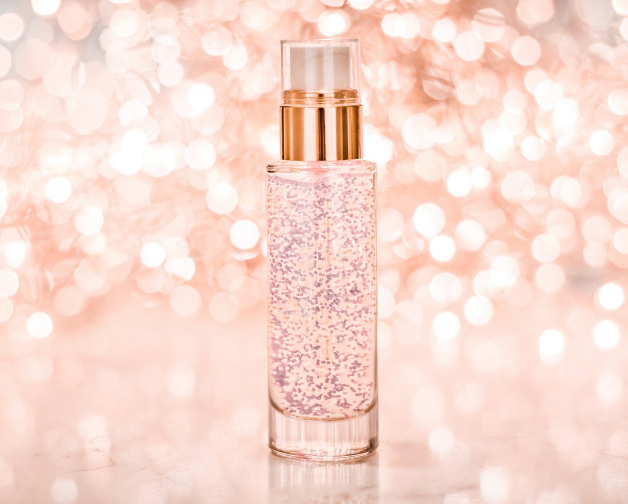 Cosmetic branding, blank label and glamour present concept - Holiday make-up base gel, serum emulsion, lotion bottle and rose gold glitter, luxury skin and body care cosmetics for beauty brand ads; Shutterstock ID 1541955560; purchase_order: COG FLY Cosmospheres; job: ; client: ; other: 