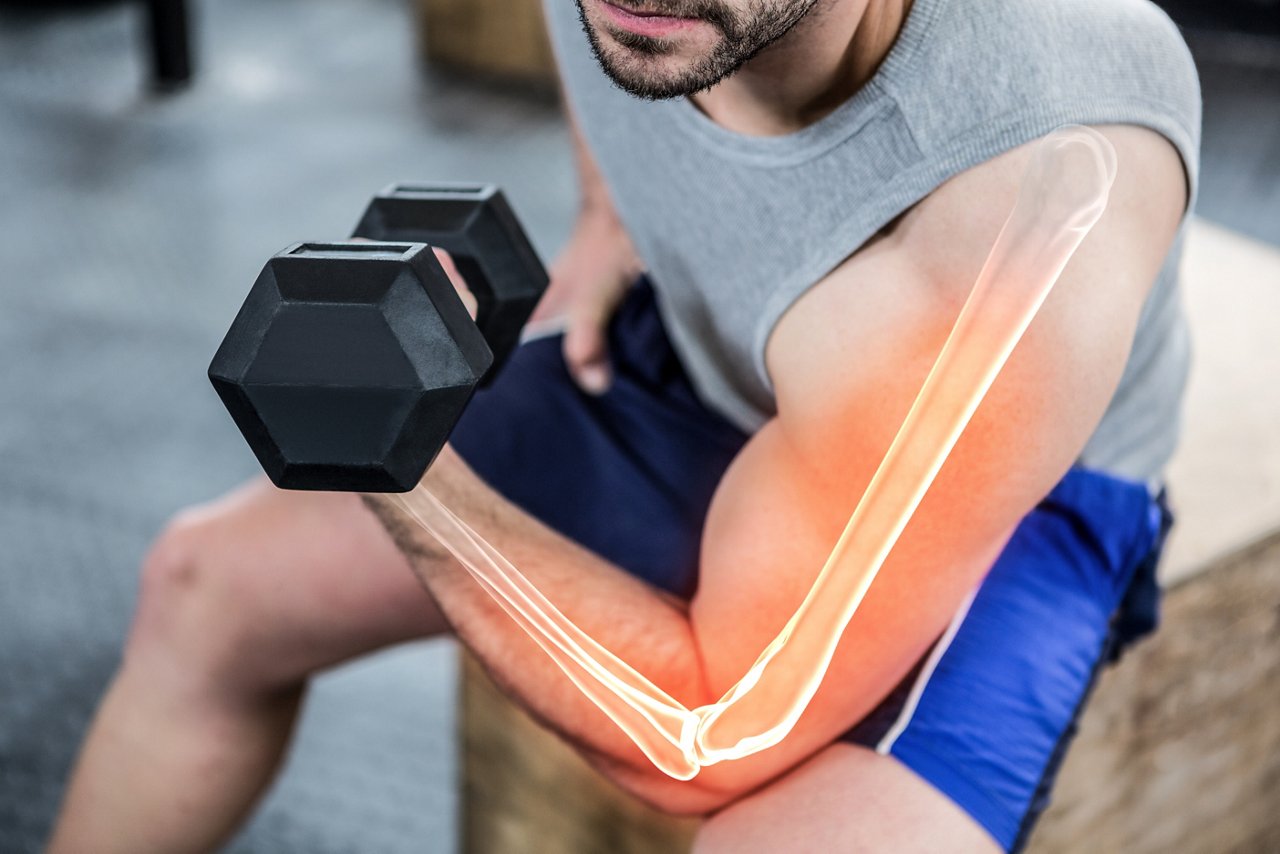 Digital composite of highlighted arm of strong man lifting weights at gym; Shutterstock ID 660959431; purchase_order: COG LinkedIn; job: ; client: ; other: 