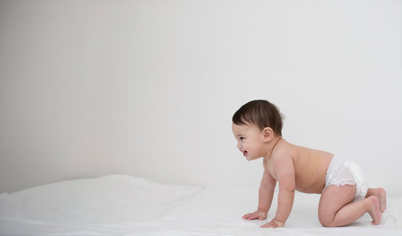 Baby wearing diaper crawling 
