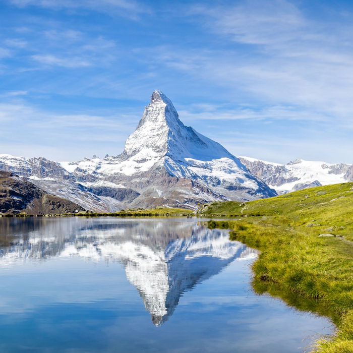 Snowy mountain range reflected on a lake