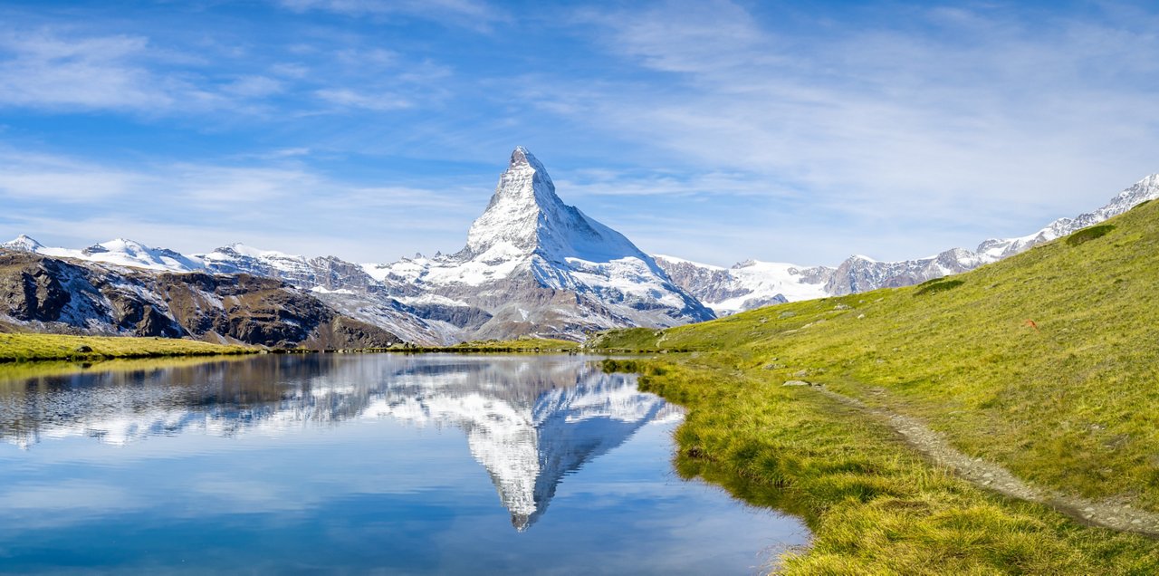 Snowy mountain range reflected on a lake