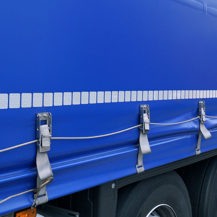 Truck transport. View of the tarpaulin covering the semi-trailer of the truck. ; Shutterstock ID 1464572615; purchase_order: POL_website_Automotive; job: ; client: ; other: 