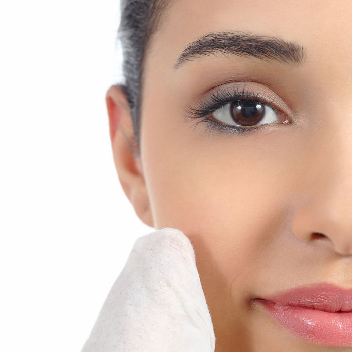 Close up of a woman face removing make up with a baby wipe isolated on a white background              ; Shutterstock ID 161645882