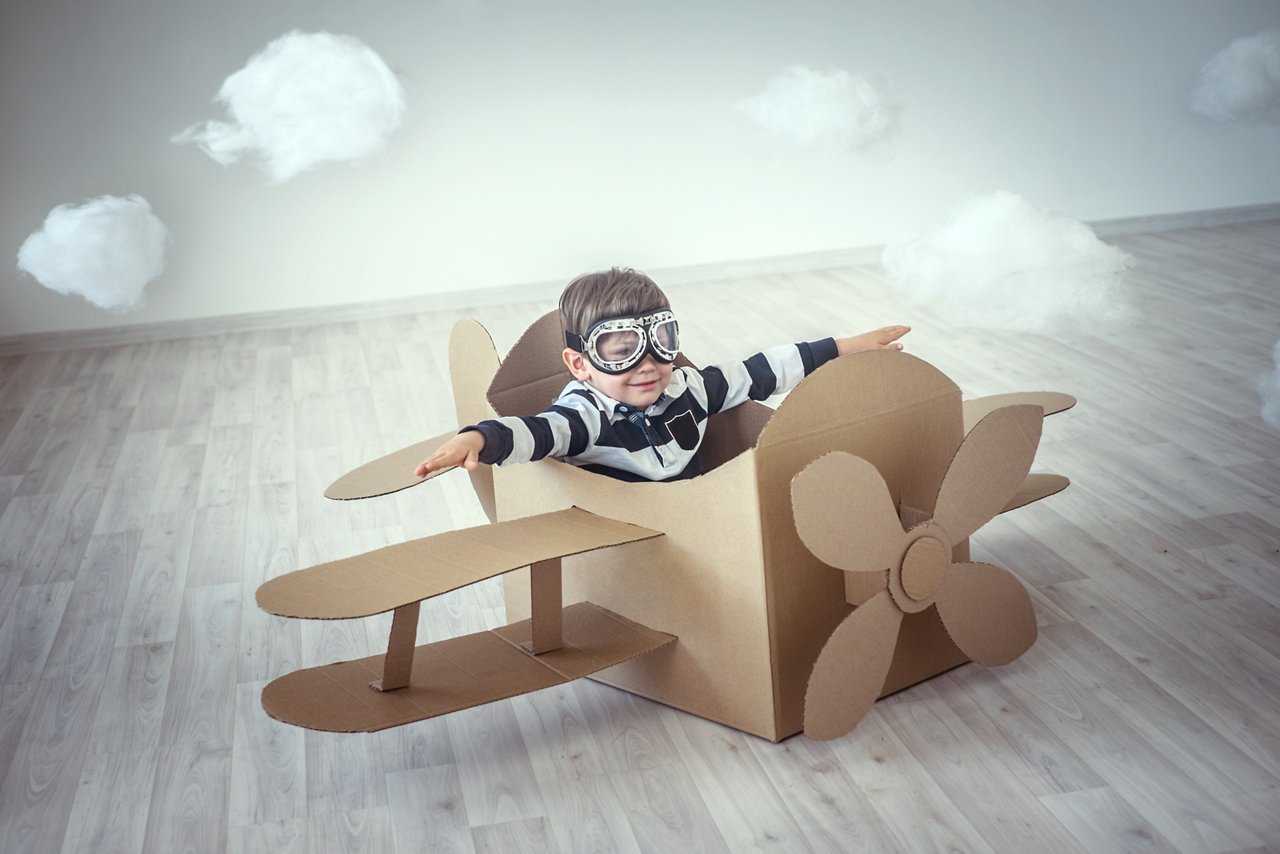 Little boy in a cardboard airplane; Shutterstock ID 224906884