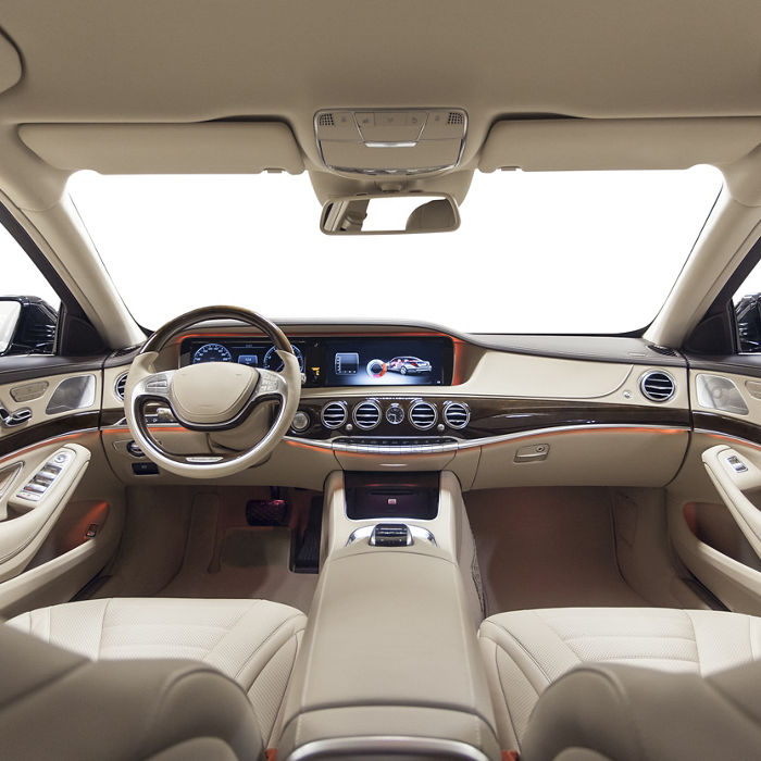 Car interior luxury. Beige comfortable seats, steering wheel, dashboard, climate control, speedometer, display, wood decoration & orange ambient light; Shutterstock ID 374122960; purchase_order: GDS_Engineered materials automotive; job: ; client: ; other: 