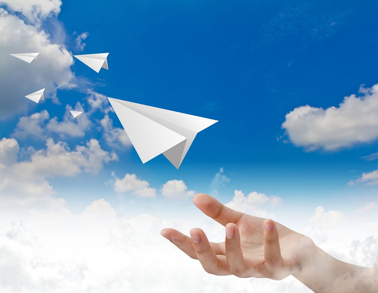Hand throwing a paper plane in the sky; Shutterstock ID 97985369