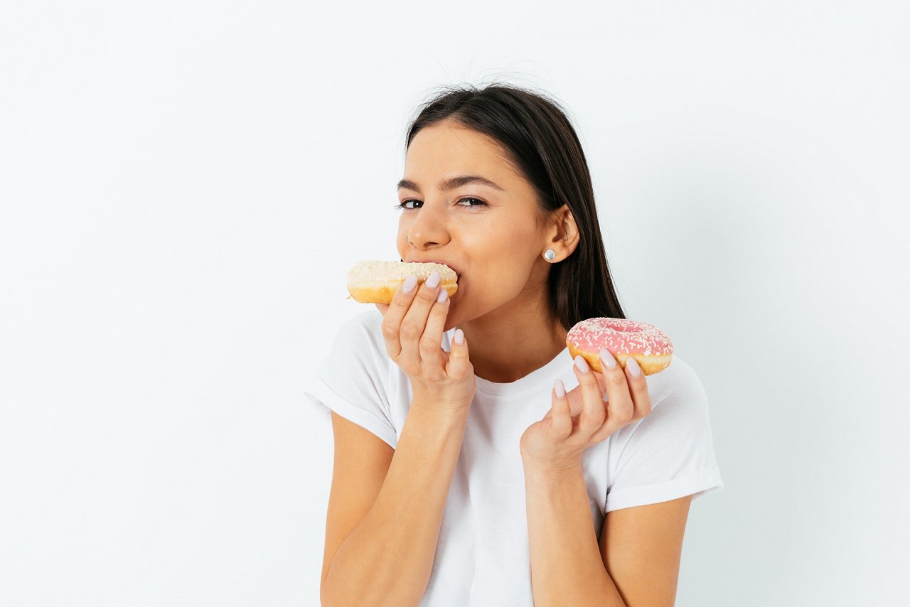 Portrait of joyful young woman eating donuts isolated over white background.; Shutterstock ID 1914710890; purchase_order: COG; job: COG; client: COG; other: COG
1914710890